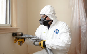 Employee installing spray foam.